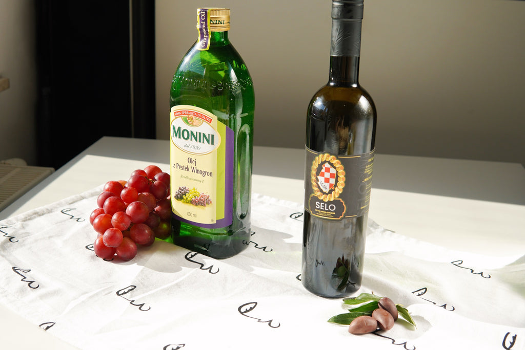 Grapeseed oil bottle placed on a marble countertop, presenting a seamless blend of elegance and natural beauty.